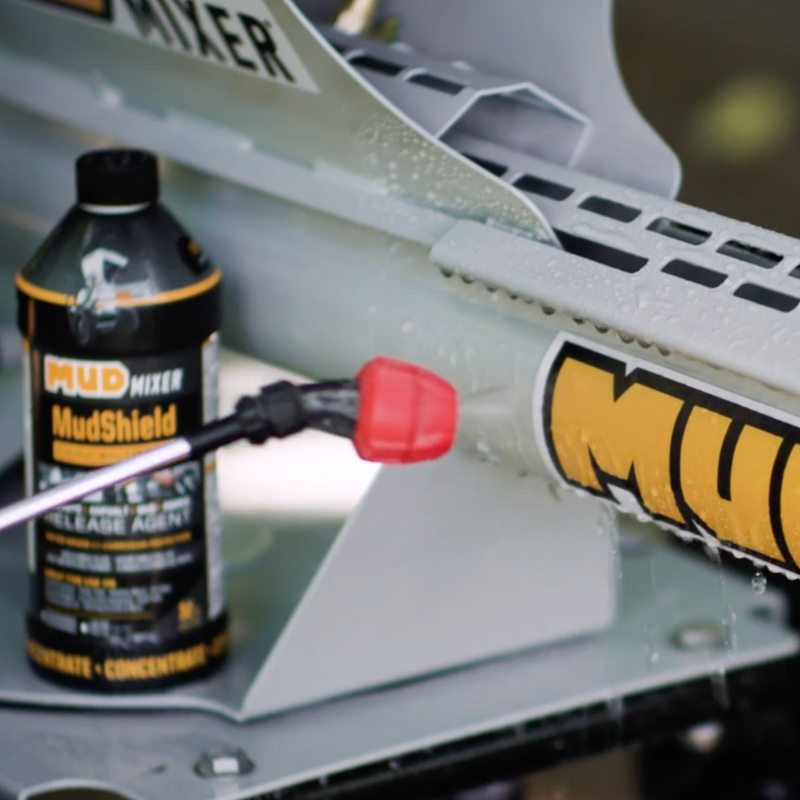 MudShield product being applied to a MudMixer with a bottle of the product in the foreground.