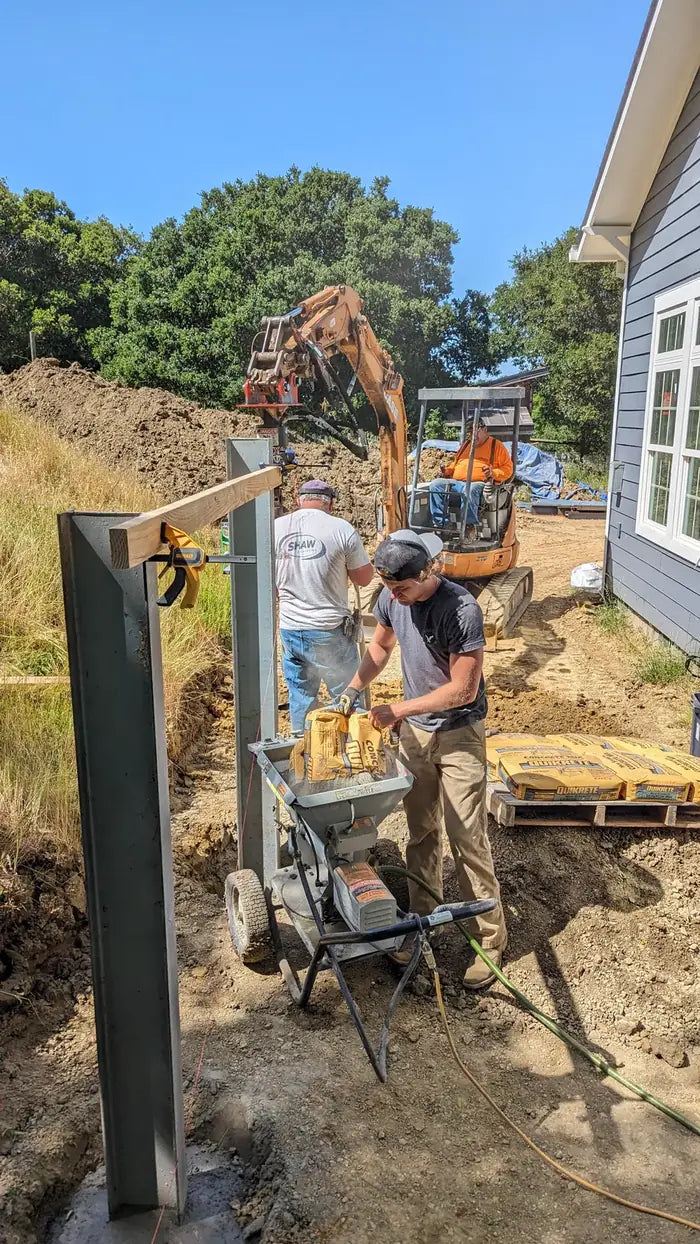 Crew setting a fence post with a MudMixer